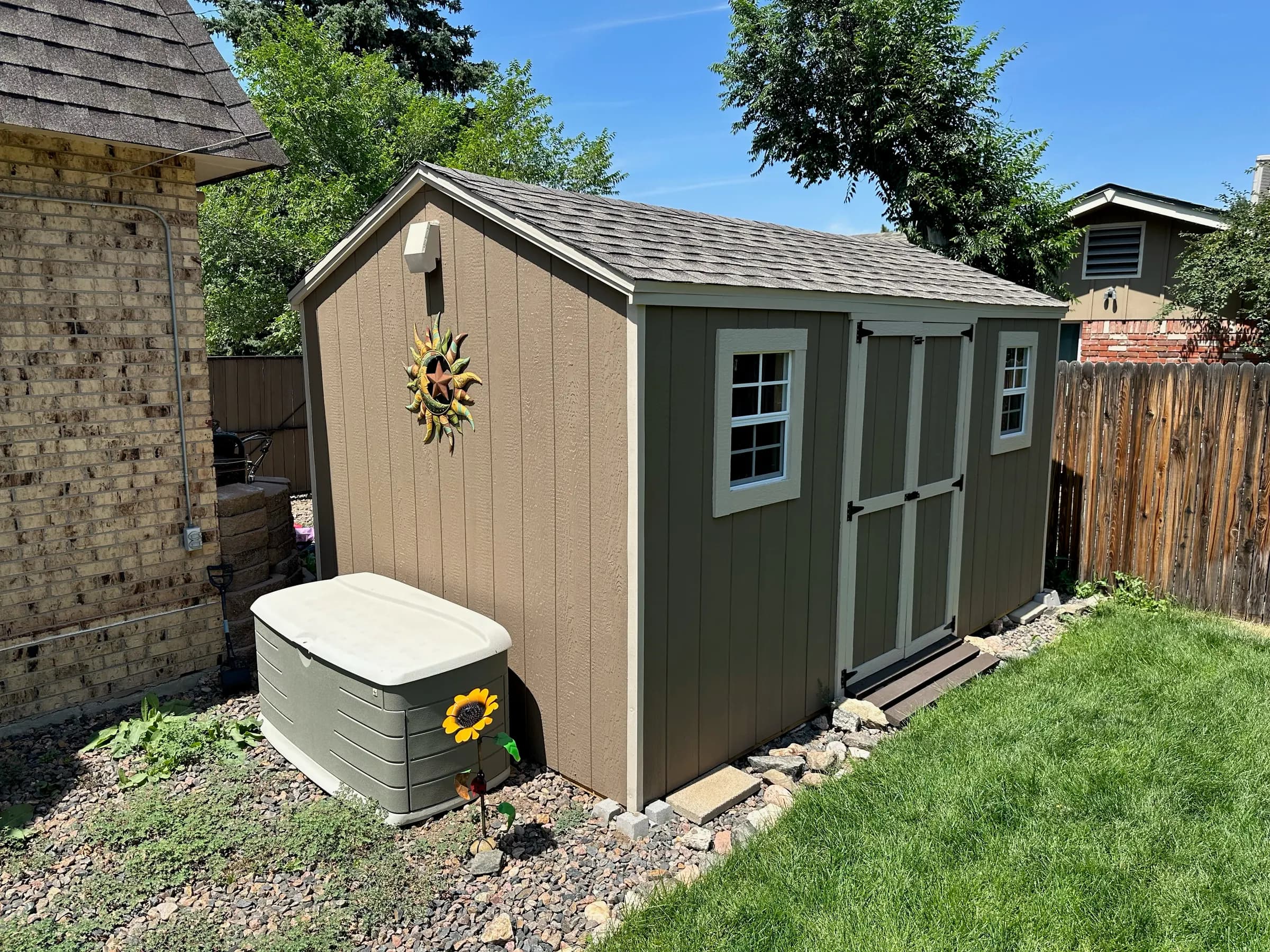 Backyard shed beside a cedar privacy fence